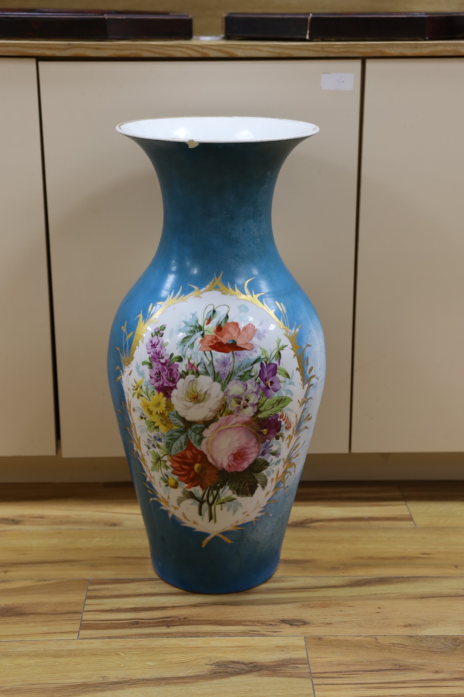 A large blue Sevres vase with sectioned botanical decor, 67cm tall